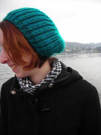 Side profile photograph of Steph Fletcher in a green hat