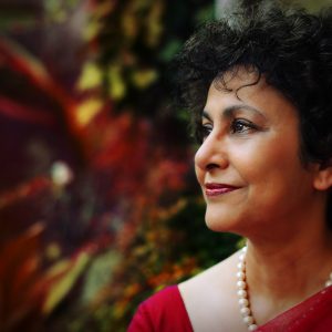 Jamie Wilson, Irene Khan (2014). Image courtesy of photographer. Photograph of side profile of a woman (Irene Khan) with plants in the background.