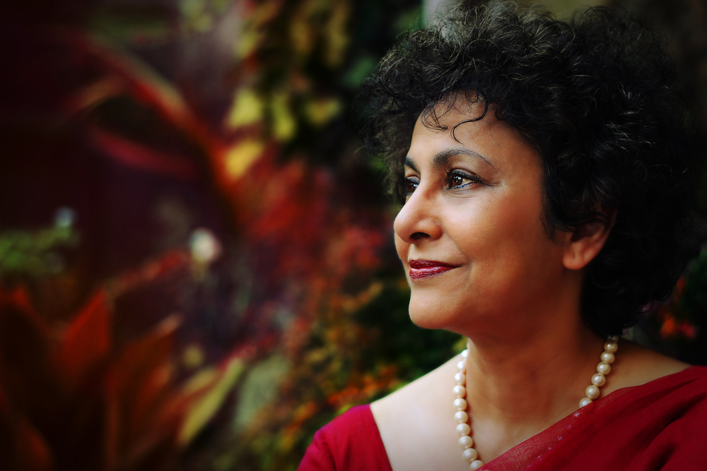 Jamie Wilson, Irene Khan (2014). Image courtesy of photographer. Photograph of side profile of a woman (Irene Khan) with plants in the background.