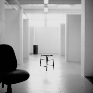 Lizzie King & Craig Tattersall, Studios (2015). Image courtesy of artists. Photograph of swivel chair in foreground and a stool in the centre of the shot in a deserted artist studio.
