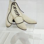 A white leather laced shoe designed for a bird's foot.