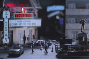 A small model of a cinema with police officer figures outside.