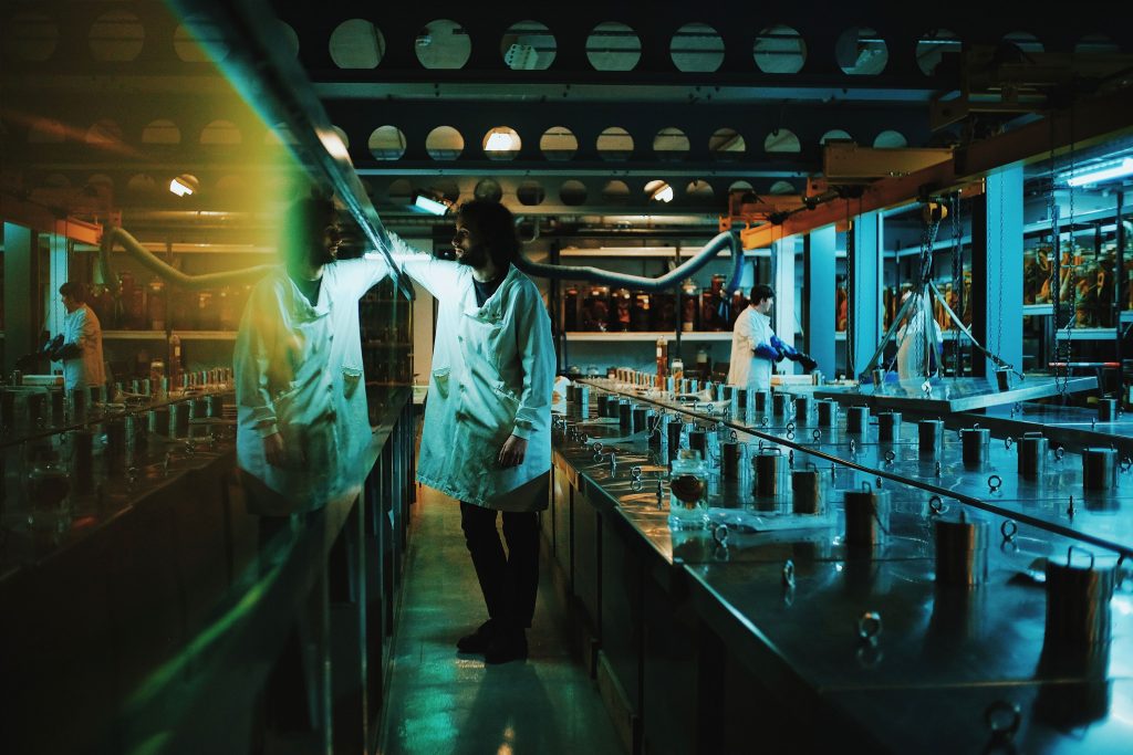 Photograph of man in a white coat in a marine laboratory.