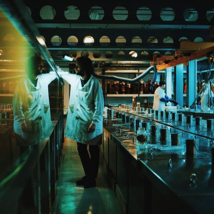 Photograph of man in a white coat in a marine laboratory.
