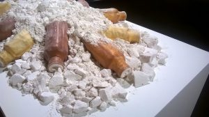 Crumbed plaster with latex bottles arranged on the pile.