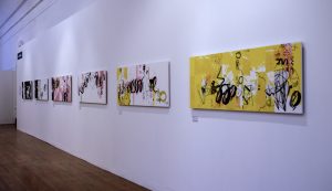 White gallery wall with a row of 4 prints on.