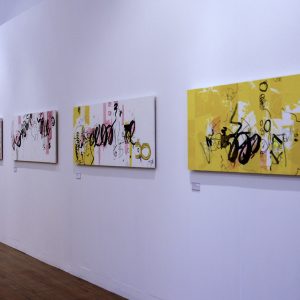 White gallery wall with a row of 4 prints on.