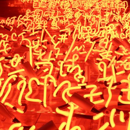 Small red neon lights of Chinese symbols on the jumbled floor.