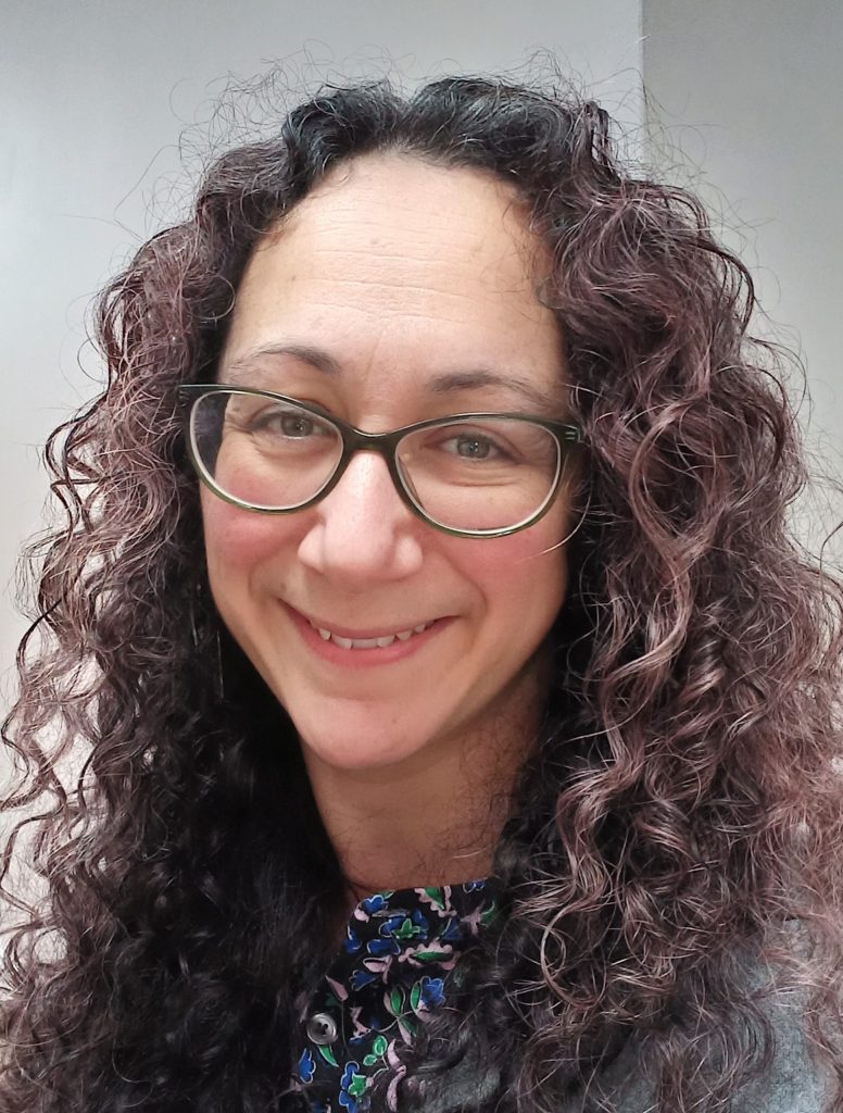 A profile photograph of Alice Correia, smiling at the camera. 