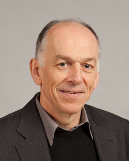 A profile photograph of Allan Walker, smiling against a grey background