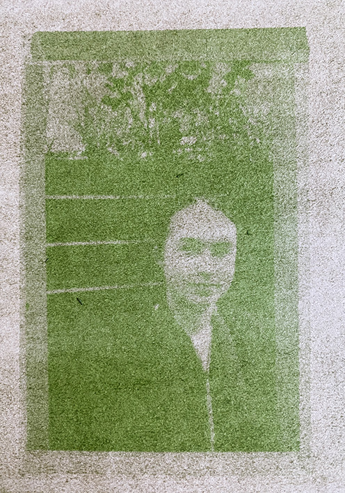 Anthotype image of yound person stood next to some plants