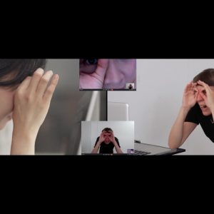 A still image from a film by artists Nicola Dale and Florence Lam. Each are taking part in a physical performance across Zoom. Each hold up their hands to their eyes.