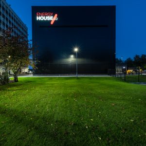 A vibrant image shows the Energy House 2.0 building illuminated at night.