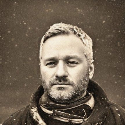 A tin type style portrait of Mishka Henner, a white man with silver hair.