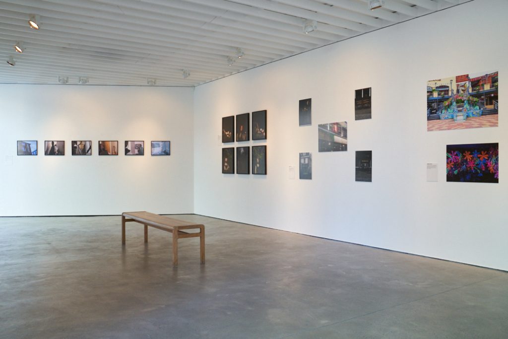 Installation view of People and Places at Open Eye Gallery, with groups of artwork presented against a white wall. 