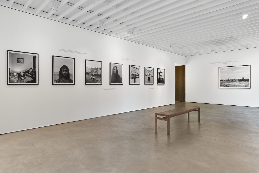 Installation view of Bank Top works at Open Eye Gallery. Large black and white images line the white wall. 