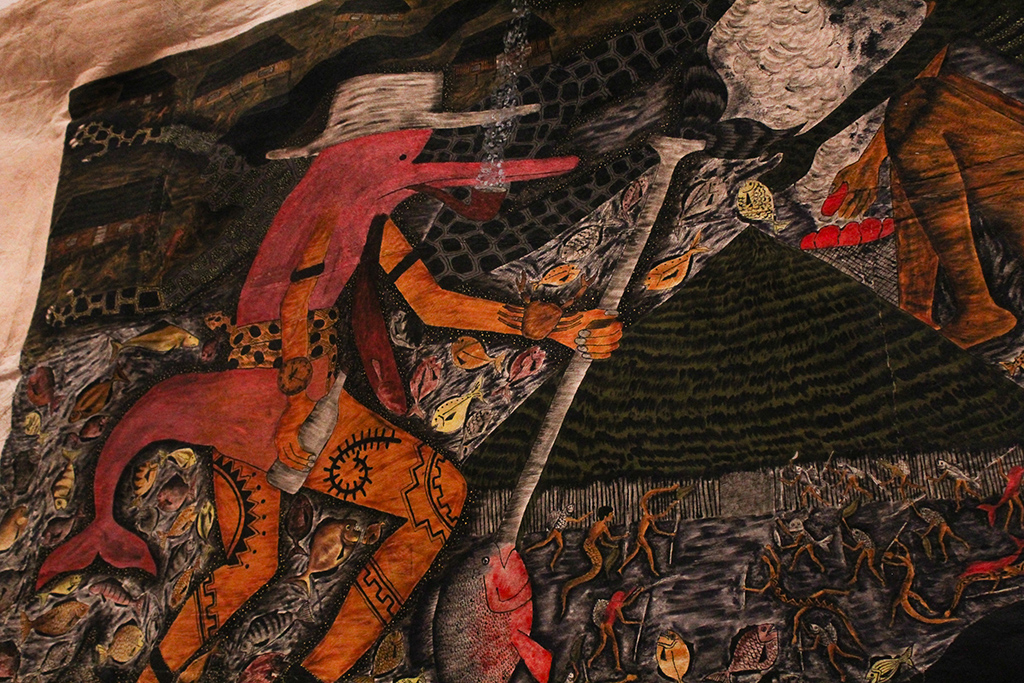 A humanoid pink dolphin smokes a pipe while holding a paddle with a fish on the bottom.