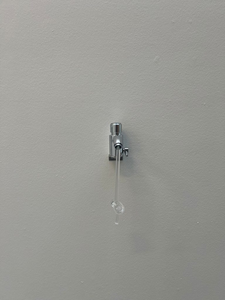 Artwork installation, tap with knotted plexiglass flows