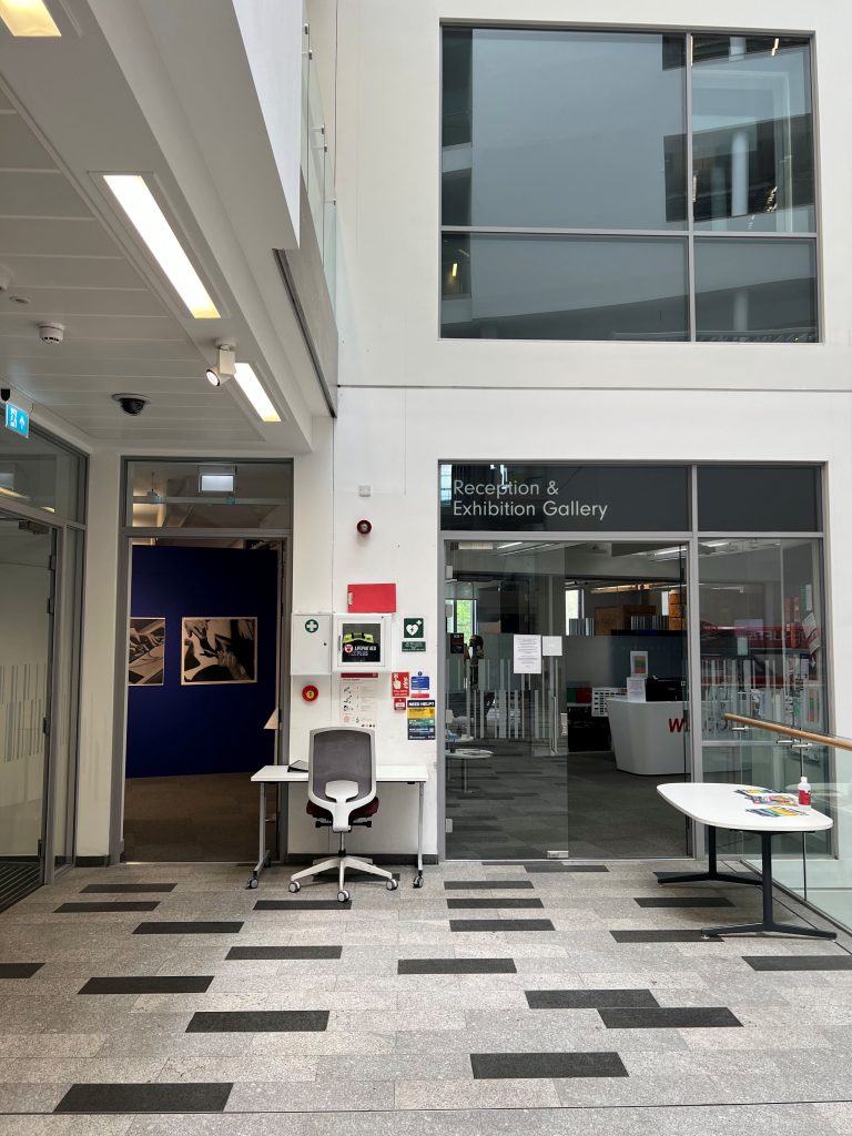 Two entrances to an exhibition gallery and reception in a university building.