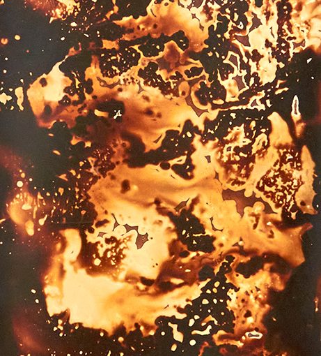 Black and orange photographic print, with liquid effect.
