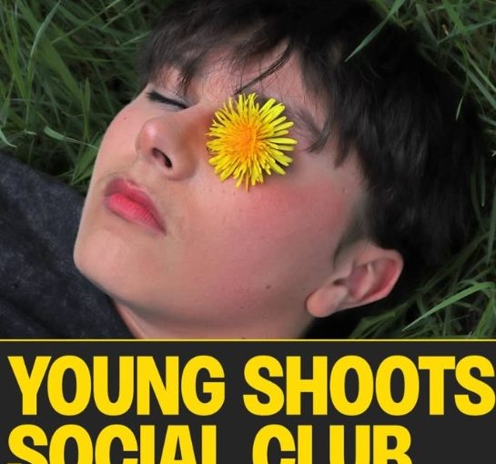 A photograph of a young person's face, looking calm, with a yellow dandelion over one eye. Underneath it reads Young Shoots Social Club